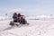 Rescuers on snowmobiles in the mountains