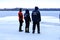 Rescuers in uniform and diving suit are on duty on the frozen river during winter fishing and sport events. Rescue service