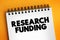 Research funding - a term generally covering any funding for scientific research, text concept on notepad