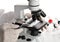 Research scientist working with specimen plate on microscope wit