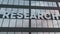 Research sign on a modern glass skyscraper. Research glass building