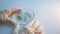 Research of viruses and bacteria, researcher holds a Petri dish with a sample.