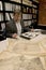 Researcher in archive, searching through maps and photographs.