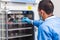 Researcher introducing a cell culture flask into an incubator