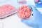 Researcher show ground meat in petri dish
