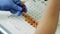 Researcher works with samples on a tray.