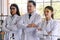 Researchers in white coat and protective eyeglasses standing arms crossed together in the laboratory