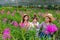 Researchers, young women wearing white dresses and orchid garden owners are collaborating to inspect orchids and save changes