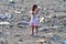 RESEN, MACEDONIA -  JULY 23 : Unidentified child is looking at magazine paper in a garbage dump