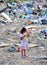 RESEN, MACEDONIA - JULY 23 : Unidentified child is looking at magazine paper in a garbage dump