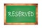 RESERVED text written on green school board