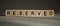 RESERVED word made with building blocks on gray table