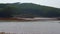 Reservoir, green hills, trees, lake scenery outdoors on a sunny day