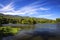 Reservoir under blue sky with a mountain backdrop