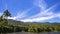 Reservoir under blue sky with a mountain backdrop