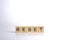 RESET - word of wooden blocks with a letter on white background