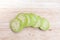 A resh green eggplant sliced on wooden board