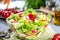 Resh vegetable salad on grey beton table closeup.