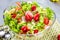 Resh vegetable salad on grey beton table closeup.