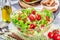 Resh vegetable salad on grey beton table closeup.