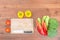 Resh vegetables and knife on cutting board on wood table