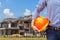 Resident engineer holding yellow safety helmet at new home building