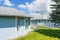 Residential area with exposed patio, white railings on cloudy sky background.