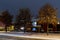 Residential area and parking lot evening lighted houses and road in the snowy