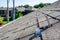 Residential asphalt shingle roof with metal anchors installed for the installation of a solar panel rail and racking