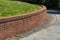 Residential brick retaining wall, curved along driveway