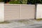 Residential brown clear sand home suburb metal aluminum house gate street wall