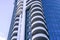 Residential building with balconies, multi-storey building. Building against the blue sky with clouds