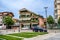 Residential building with flower balconies on a city street in Shkoder. Cityscape with modern