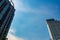 Residential building and office buildings on a cloudy blue sky background