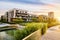 Residential building in the public green park during sunrise