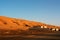 Residential building under the desert dunes wahiba sands at sunset