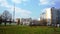 Residential buildings, communication tower, lawn and trees in spring in Moscow