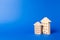 Residential buildings figurine stands on a blue background. The concept of buying and selling real estate, renting. Search