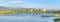 Residential buildings near the Oquirrh Lake with docks and view of mountains at the back