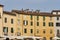 Residential buildings on oval Amphitheater Square in Lucca, Ital