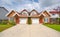 Residential duplex building with concrete drive way and green lawns in front