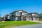 Residential duplex building with concrete drive ways and green lawns in front