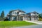 Residential duplex building with concrete drive ways and green lawns in front