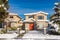 Residential duplex house with front yard in snow on winter sunny day in Canada