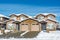 Residential duplex house with front yard in snow on winter sunny day in Canada