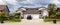 Residential duplex townhouse with black car parked on concret driveway