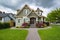 Residential family house with concrete pathway over front yard