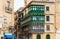 Residential house facade with traditional Maltese wooden balconies in Valletta, Malta