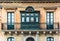 Residential house facade with traditional Maltese wooden balcony