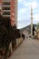 Residential house fenced overgrown wall on the street and mosque on background in the Alanya city.